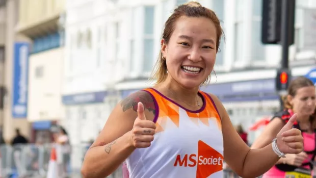 Marathon runner with arms up