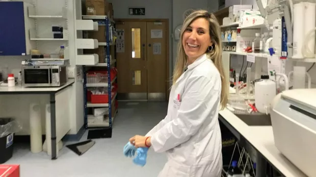 Dr. Irene is smiling at the camera in the middle of her research lab