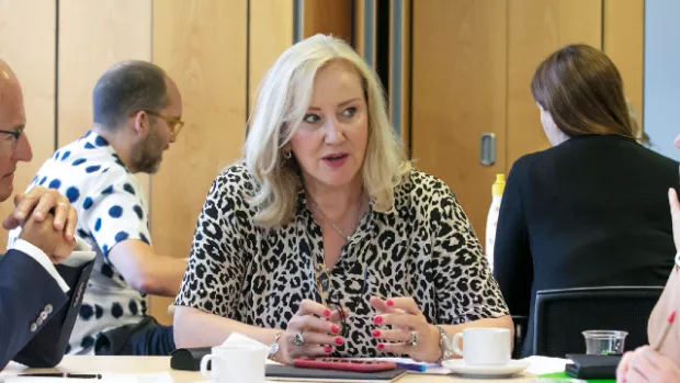 MS Society Council Chairs and Trustees sit at a table having a discussion