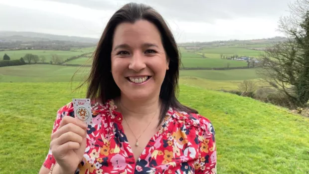 The photo shows Romi holding her Shining Star award as she smiles at the camera