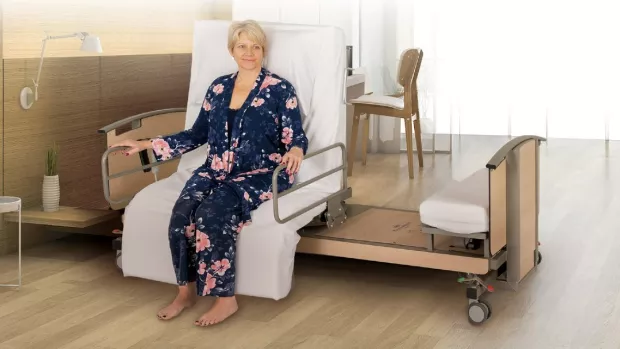 Image shows a woman sitting on a turning bed