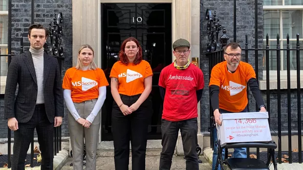 People with MS and MS Society staff outside 10 Downing Street with a petition