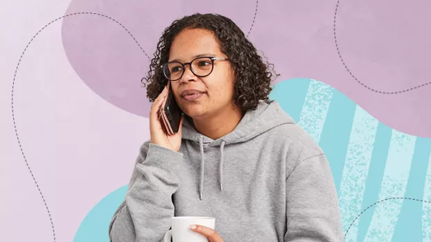 Black woman with MS holding a smart phone to her right ear