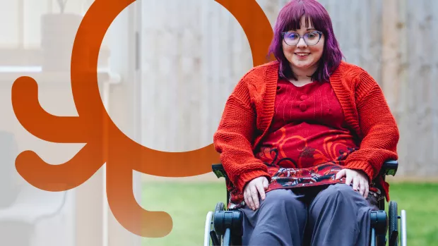 Sabrina is sitting in her wheelchair, smiling at the camera with an orange Octopus logo in the background.