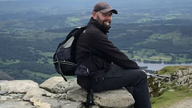 Scott sitting on a rock during a hill walk