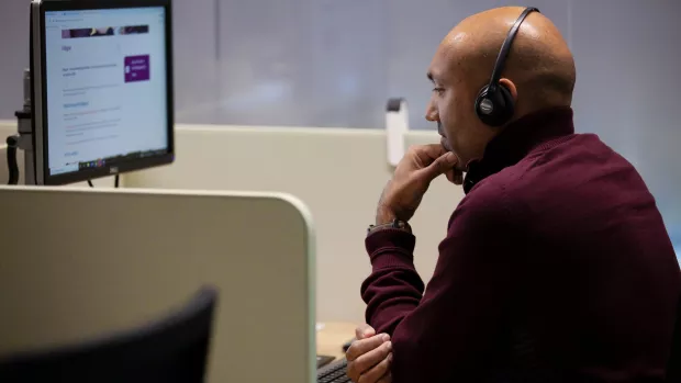 MS Society staff member using headset