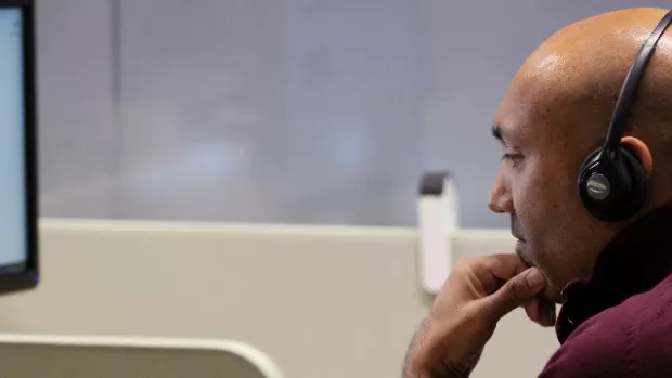 MS Society staff member using headset