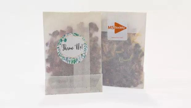 The photo shows two packs of dried flower wedding confetti with MS Society branding