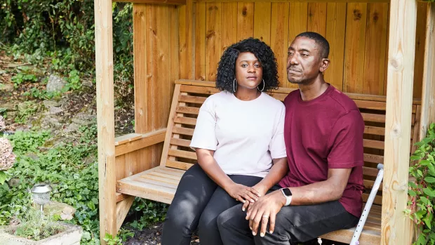 Simone and Nikoma sit on a garden bench.