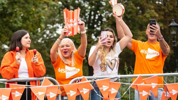 Four people cheering during an MS Society event