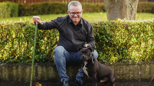  A man with MS sitting outside with his dog