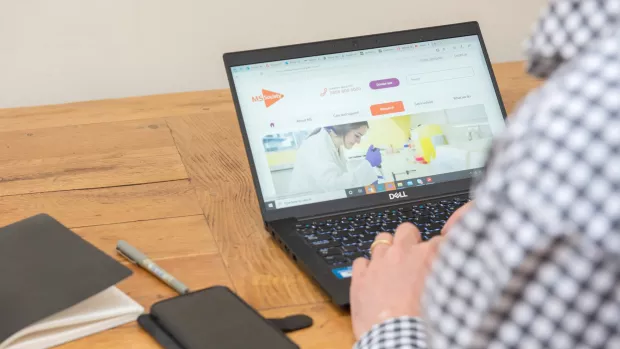 A man typing on a laptop