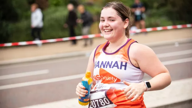 A woman in an MS Society top running a marathon