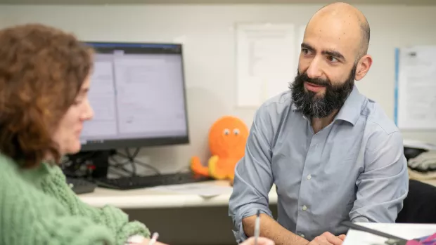 A researcher talks to a research participant 