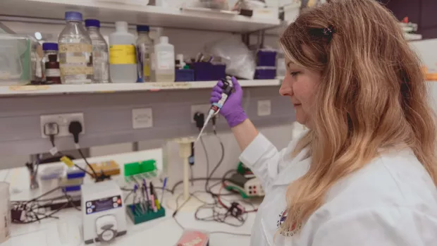 A researcher at work, surrounded by scientific equipment