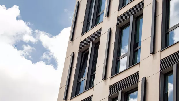 An office block with blue skies and clouds