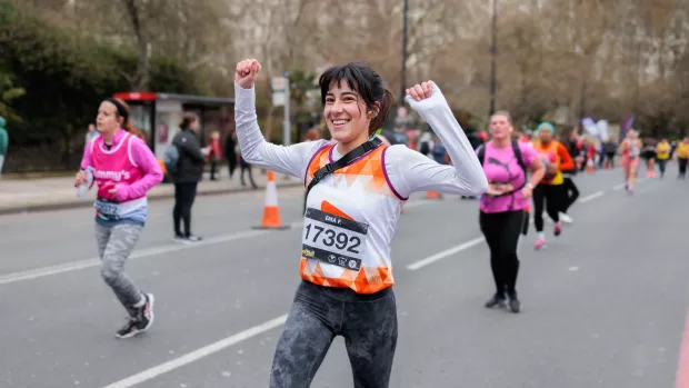 Runner in an MS Society t-shirt, holding their hands in the air