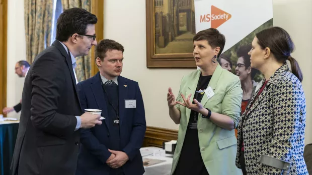 people speaking in a small group at the houses of parliament