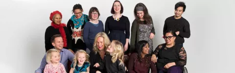 A photo of a group of people laughing and smiling