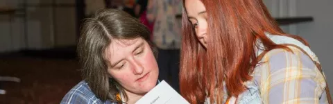 Two women look at an information leaflet