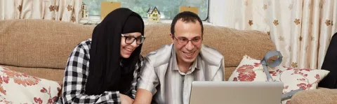 Couple at home on laptop