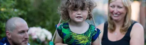 Photo: Family playing in garden with young daughter