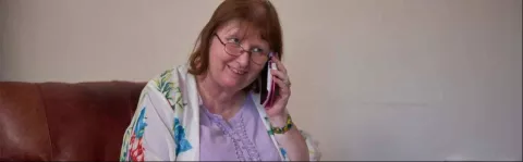 Photo: Woman at home on the phone