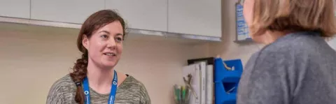 Photo: Woman with MS talking to health care professional