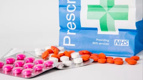 a photo of a NHS pills and prescription bag