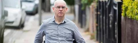 Photo: Man with MS outside in a wheelchair