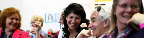 Photo shows a group of four people enjoying themselves at an MS Society event.