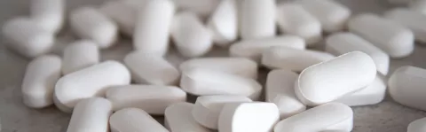 White tablets spread across a table