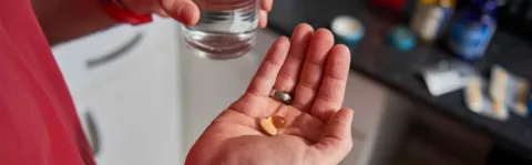 Close up of hand holding some pills