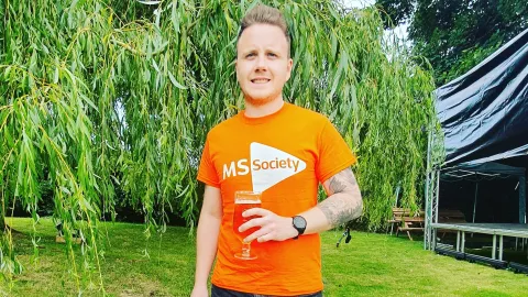 James outside wearing an MS Society t-shirt