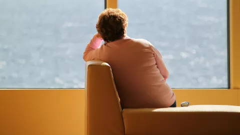 Woman on her own looking out to sea