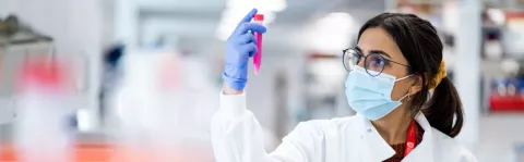 Researcher using a centrifuge, a piece of equipment used to spin liquids at high speeds