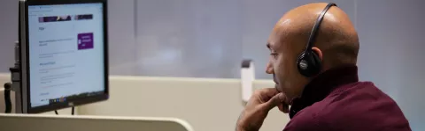MS Society staff member using headset