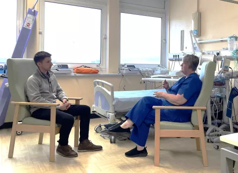 Person with MS and a healthcare professional speaking in a hospital