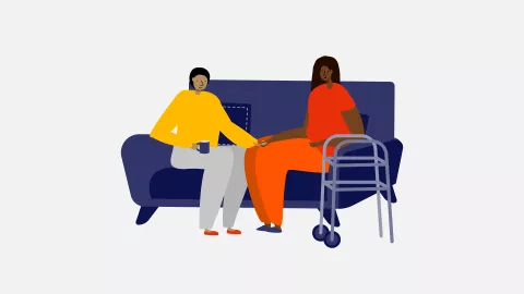 A couple seated holding hands to 'softly' show disability - Mid 30s