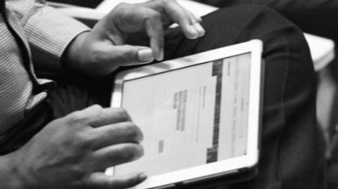 a Picture of a person completing a questionnaire on a tablet