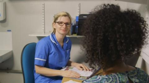 Image shows an MS health care practitioner with a patient