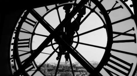 Image shows a black and white clock tower