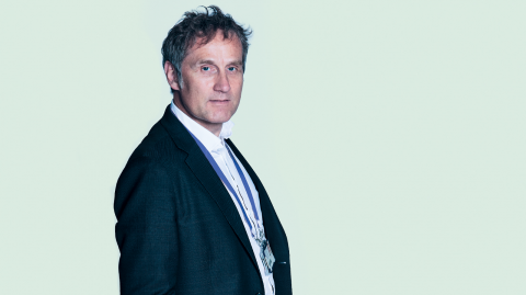 Image of Prof Klaus Schmierer standing against a pale blue background
